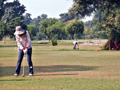 walking the green diverse group of golfers plays at a casual event