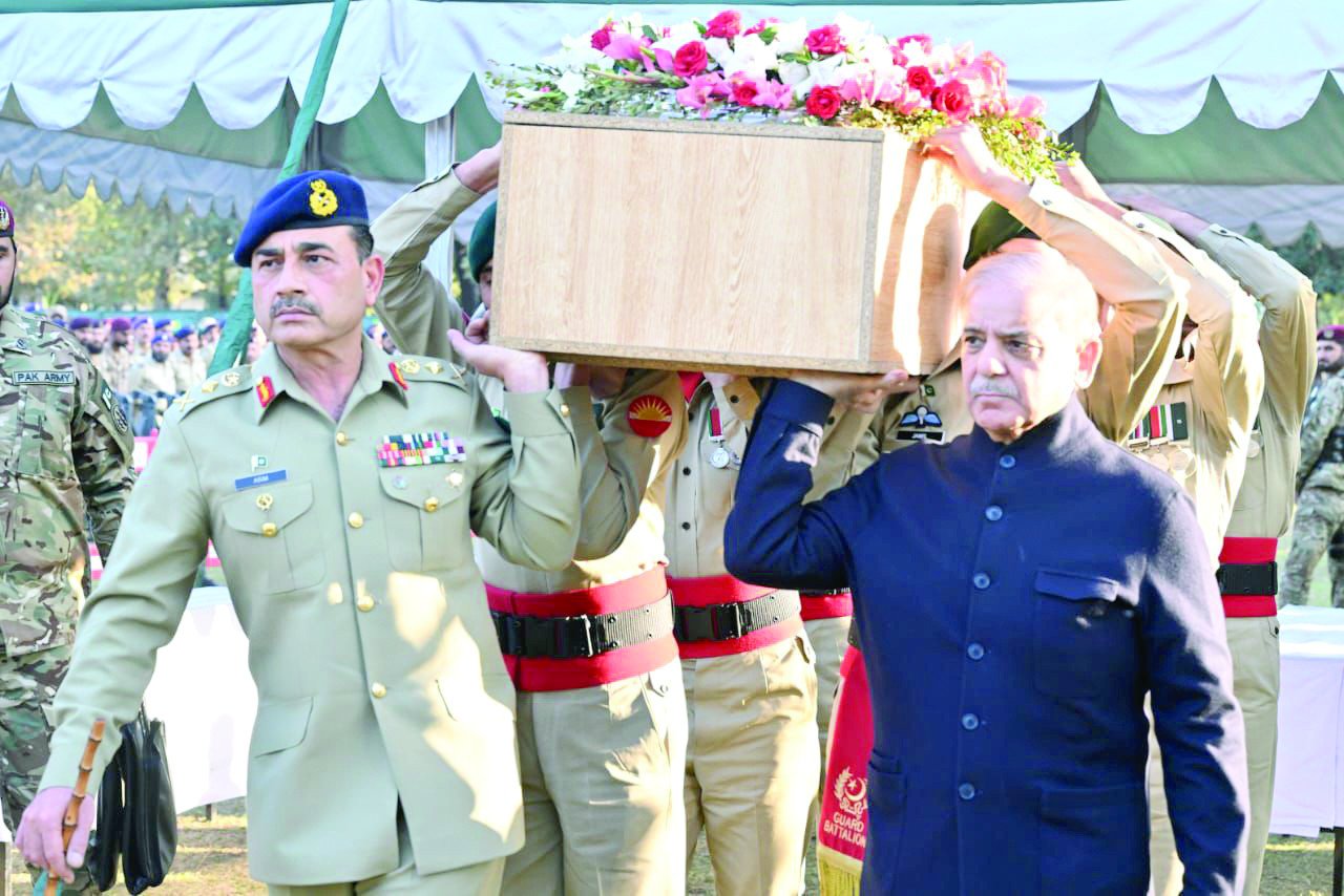 prime minister shehbaz sharif and coas gen asim munir carry the coffin of a soldier martyred during the protest in the federal capital photo express