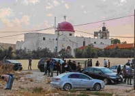 people and security forces gather outside a greek orthodox church in the hammoud village in jordan after a shooting incident photo afp