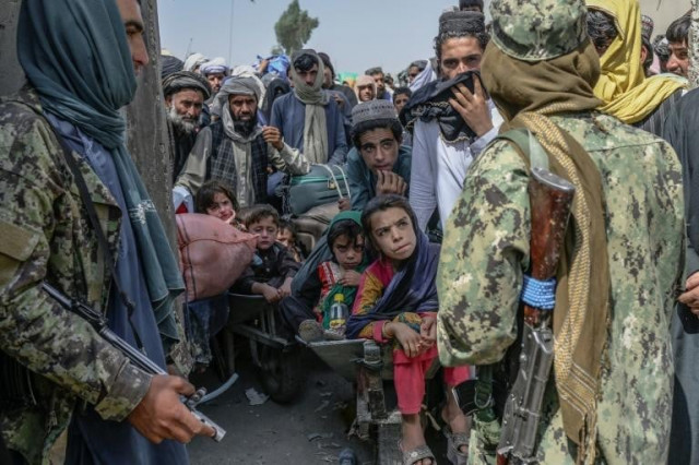 the new taliban rulers insist afghans need to stay and rebuild their conflict ravaged country photo afp the new taliban rulers insist afghans need to stay and rebuild their conflict ravaged country photo afp