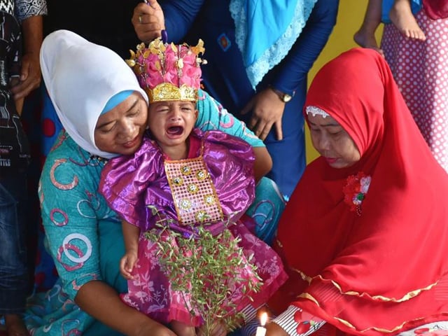 in this photograph taken on february 20 2017 toddler salsa djafar c cries during a circumcision ceremony in gorontalo in indonesia 039 s gorontalo province photo getty
