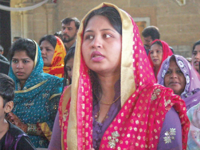 a woman devotee singing during the morning mass at st andrew s church in saddar photo file a woman devotee singing during the morning mass at st andrew s church in saddar photo file
