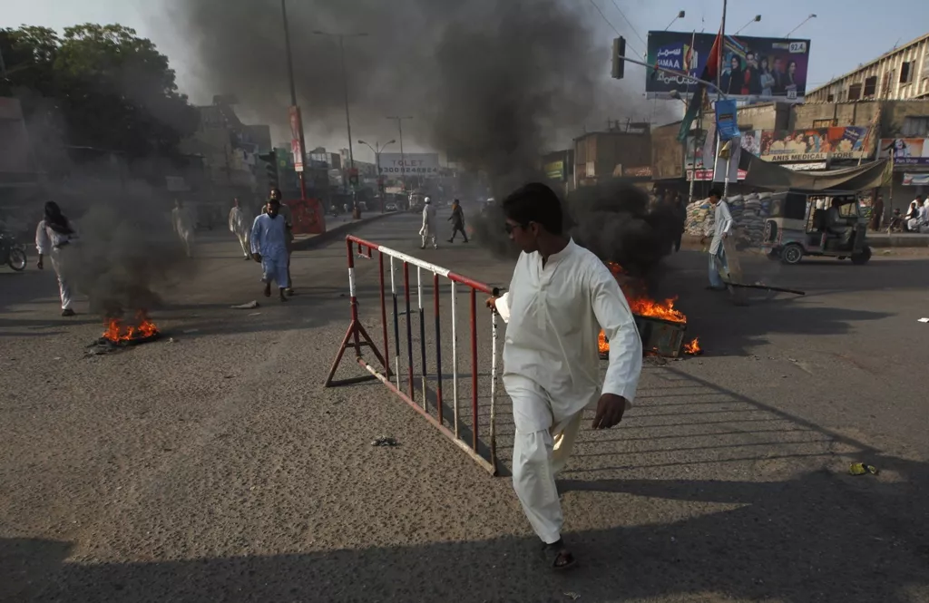 a boy pulls an iron barrier during a protest against the killings by unidentified gunmen in karachi december 25 2012 photo reuters a boy pulls an iron barrier during a protest against the killings by unidentified gunmen in karachi december 25 2012 photo reuters