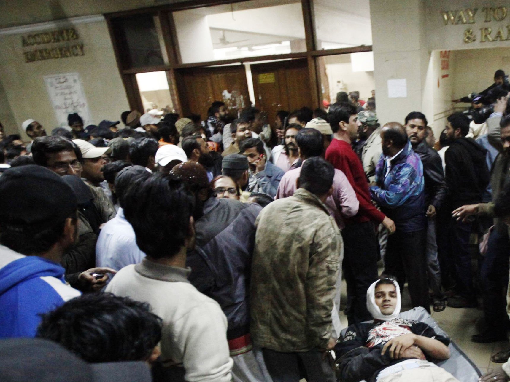 a man tries to find space to wheel an injured man through a crowded corridor of the emergency department at the abbasi shaheed hospital in karachi january 1 2013 photo reuters