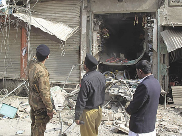 security officers inspect a damaged shop after the di khan blast on the muharram 10 procession photo file security officers inspect a damaged shop after the di khan blast on the muharram 10 procession photo file