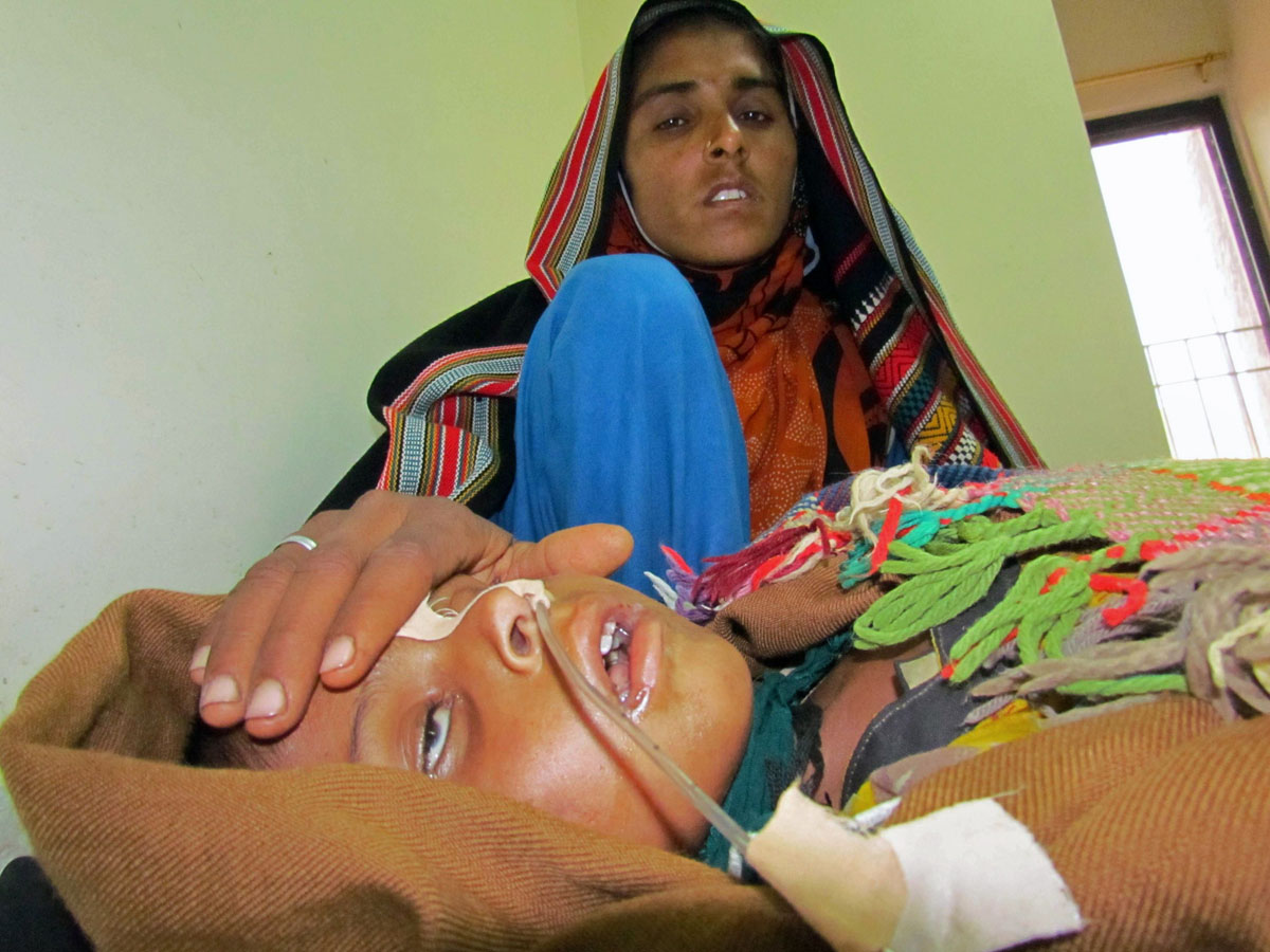 a pakistani mother tends to her young son suffering from measles at a red cross hospital in the southern sindh province city of sukkur on january 1 2013 photo afp file