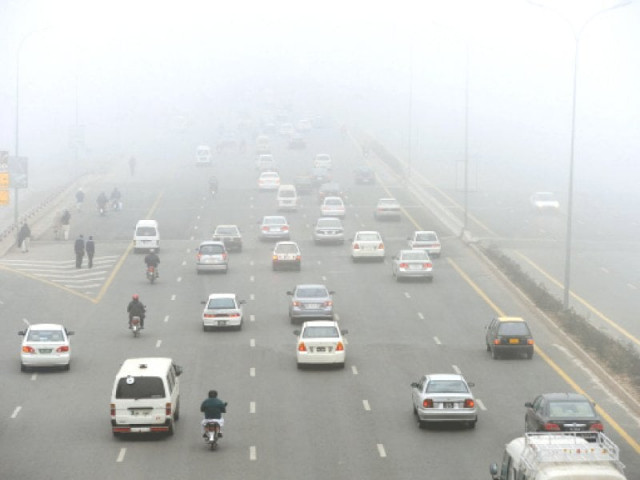 commuters travel during a cold and foggy morning foggy weather in punjab and other parts of the country has badly affected flight and rail schedules photo afp muhammad javaid express