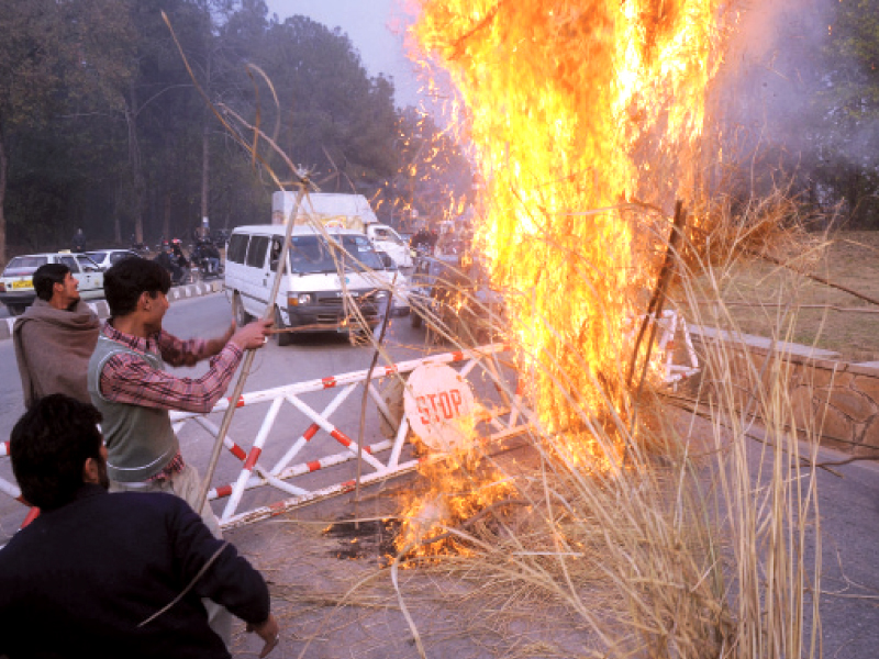 protesters burning tree branches during the protest in islamabad photo express