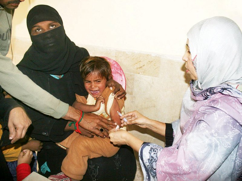 a health worker administers anti measles vaccine in karachi following the outbreak of the deadly disease in sindh photo online