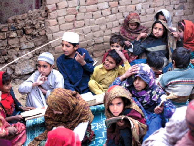 ten year old suleman gul reacts as he is scolded by his teacher during a quran study session at a makeshift school in the katchi abadi on wednesday photo myra iqbal express