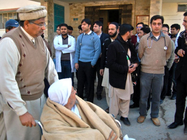 a patient on wheel chair looks at the protesting doctors outside the benazir shaheed hospital on thursday photo muhammad javaid express a patient on wheel chair looks at the protesting doctors outside the benazir shaheed hospital on thursday photo muhammad javaid express