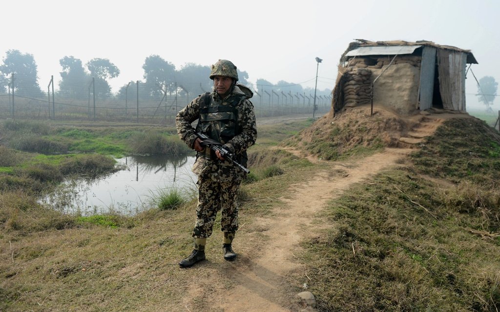 an indian border security force bsf soldier keeps watch at an outpost along the india pakistan border in suchit garh photo afp file