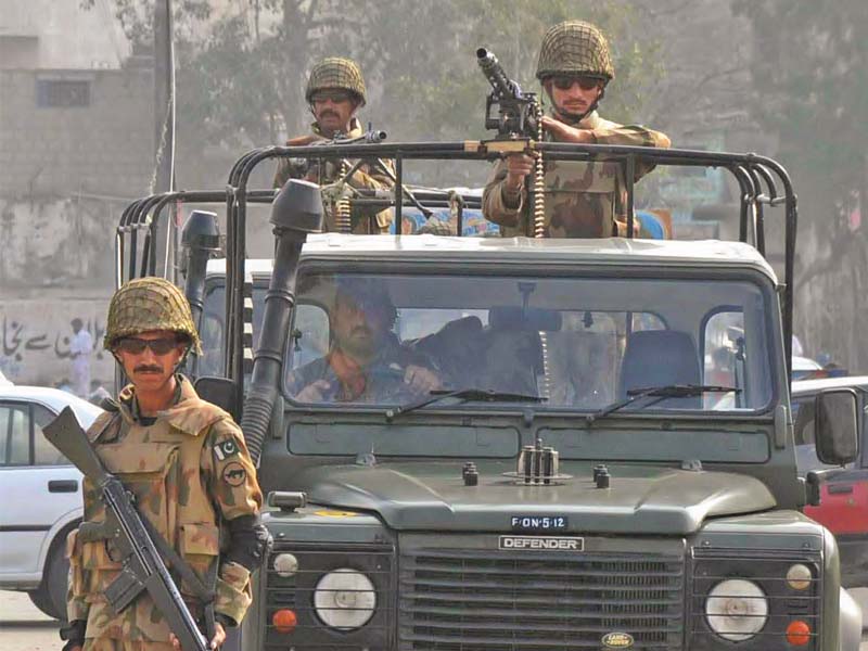 army personnel stand guard in the sultanabad area while election commission staff complete the housing census in the area on friday photo rashid ajmeri express