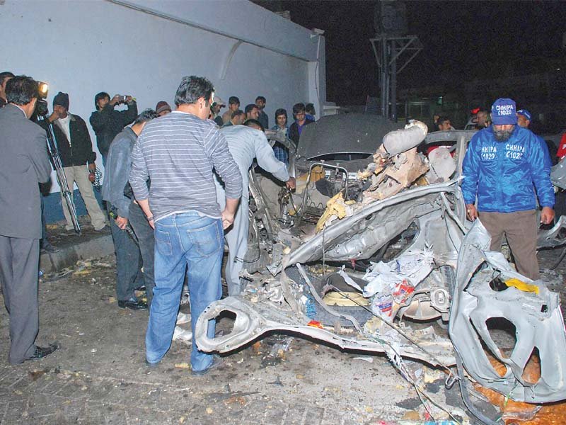 the investigation team inspects the remains of the car that exploded at askari petrol pump at 1 40am on thursday photo mohammad saqib express