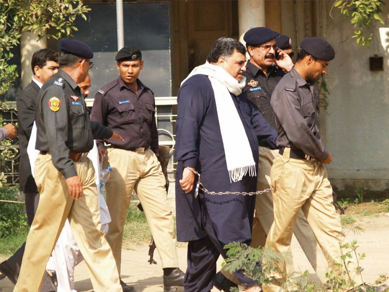 policemen lead the accused sikandar jatoi to anti terrorism court proceedings in karachi photo irfan ali express