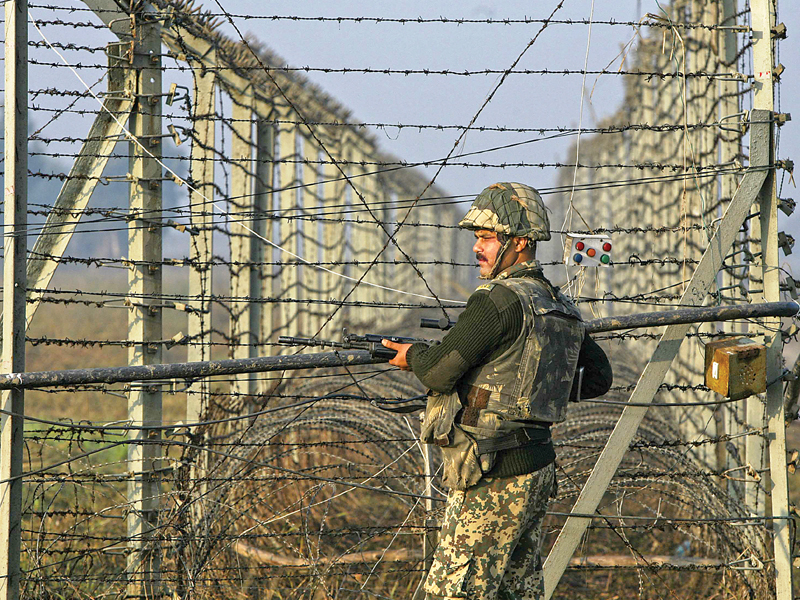 an indian soldier patrols along the border fence in suchetgarh southwest of jammu photo reuters