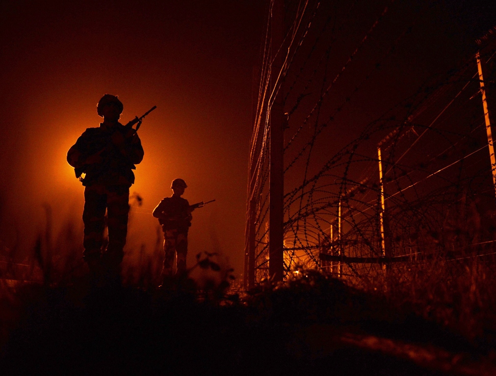 an indian border security force bsf soldiers patrols along the border fence at an outpost along the india pakistan border in suchit garh 36 kms southwest of jammu on january 11 2013 photo reuters