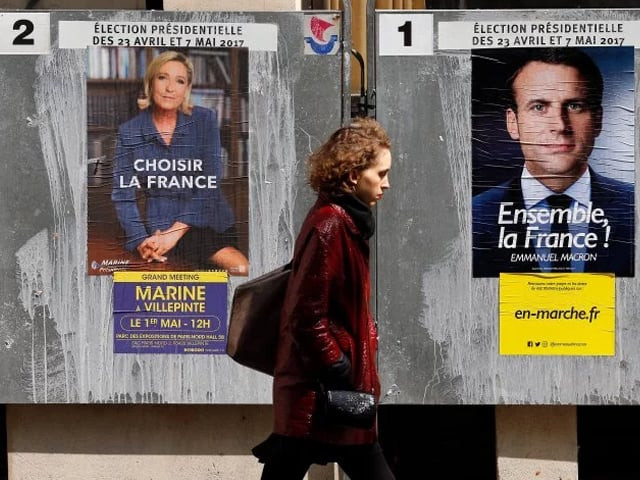 a pedestrian walks past electoral posters of french presidential election candidate emmanuel macron and far right front national party marine le pen on april 28 2017 in paris france photo getty a pedestrian walks past electoral posters of french presidential election candidate emmanuel macron and far right front national party marine le pen on april 28 2017 in paris france photo getty