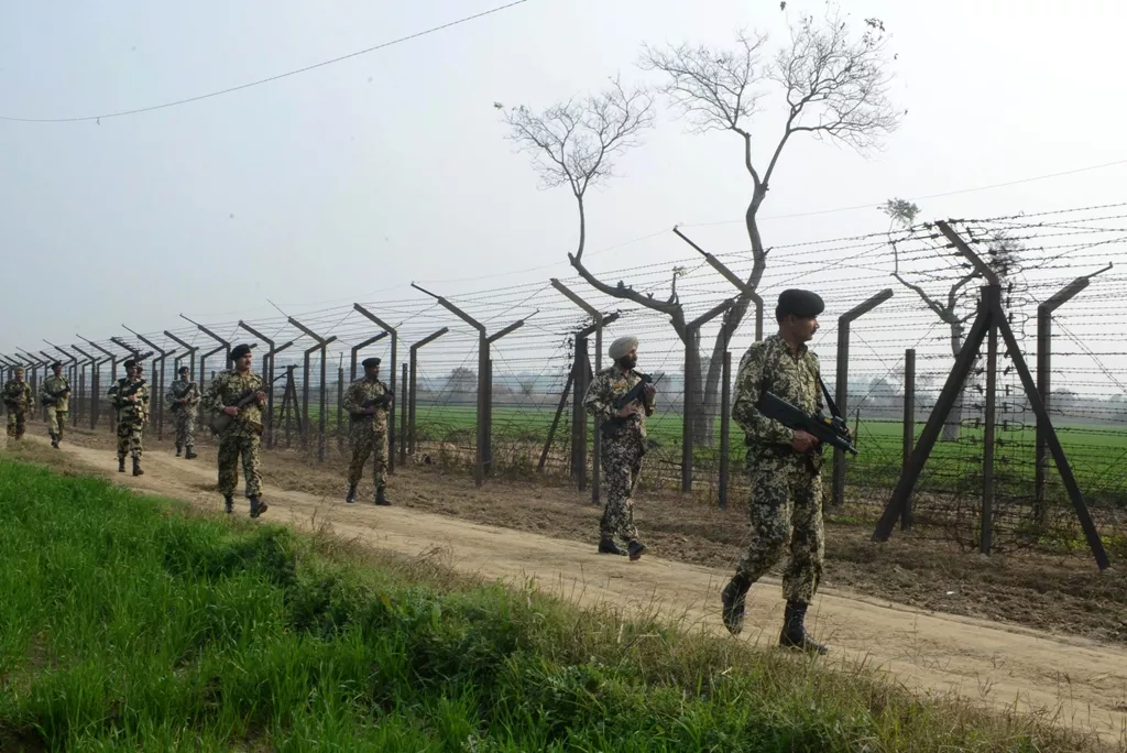 indian border security force soldiers patrol along the india pakistan border fence about 27 km from wagah on january 13 2013 photo afp indian border security force soldiers patrol along the india pakistan border fence about 27 km from wagah on january 13 2013 photo afp