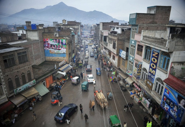 in this photograph taken on january 12 2013 pakistani pedestrians and cars travel down a main street in mingora the main town of swat valley photo afp in this photograph taken on january 12 2013 pakistani pedestrians and cars travel down a main street in mingora the main town of swat valley photo afp