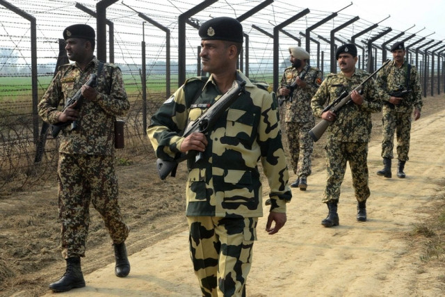 indian border security force soldiers patrol along the india pakistan border fence about 27 km from wagah on january 13 2013 photo afp indian border security force soldiers patrol along the india pakistan border fence about 27 km from wagah on january 13 2013 photo afp