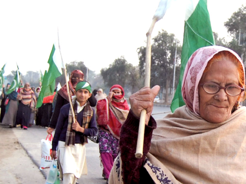 an old woman leads a group to blue area to participate the awami march photo muhammad javaid