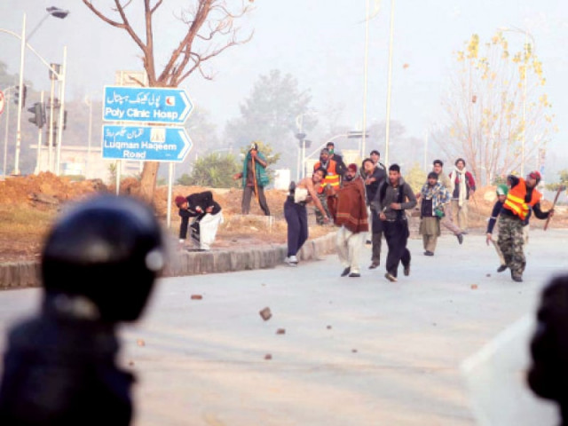 an mqi activist shows the shell of a bullet allegedly fired by the police top left activists throw stones at policemen at jinnah avenue photo nni an mqi activist shows the shell of a bullet allegedly fired by the police top left activists throw stones at policemen at jinnah avenue photo nni