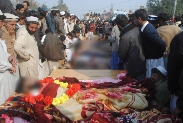 this photo shows bara tribesman social activists staging sit in outside governor house in peshawar along with bodies of the deceased photo muhammad iqbal the express tribune