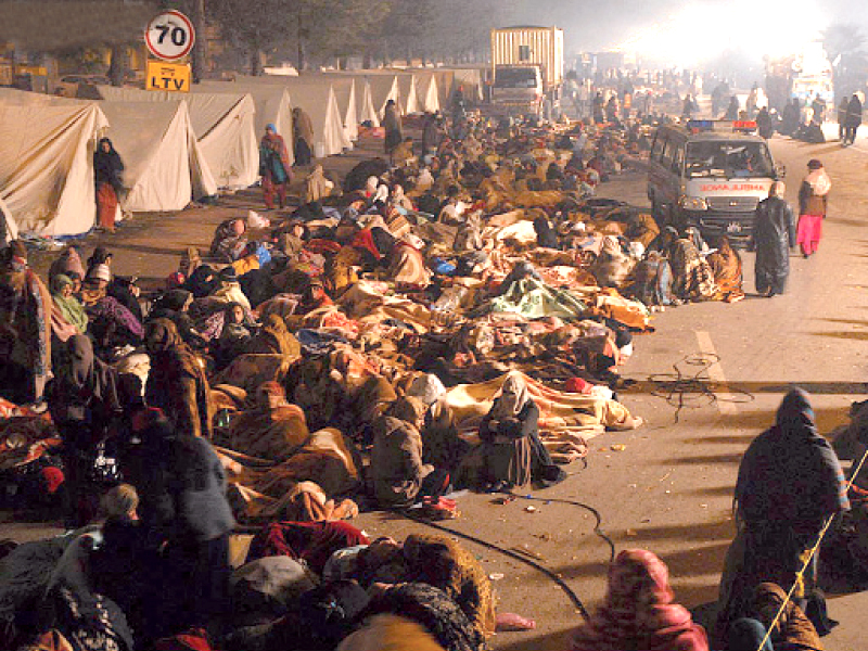 a view of the squalid conditions at the camp site above a long queue formed outside a public toilet near the protest site photo online muhammad javaid express