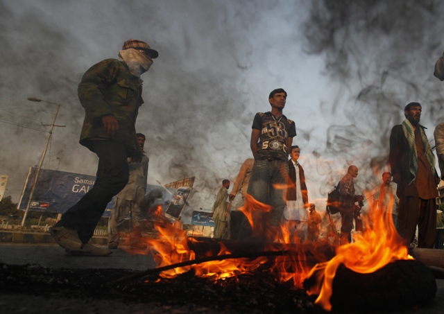 supporters of pakistan people 039 s party ppp stand near burning tyres to block a road during a protest against the supreme court 039 s decision to arrest prime minister raja pervez ashraf in karachi january 16 2013 photo reuters