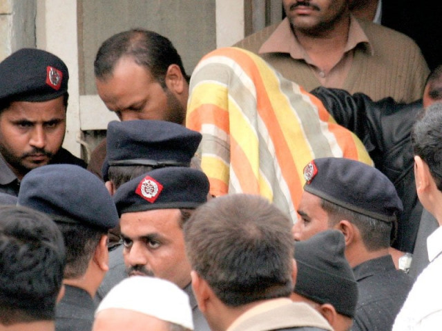 police escort prime suspect shahrukh jatoi and other suspects with covered faces after they were brought before a judge at an anti terrorism court in karachi photo athar khan police escort prime suspect shahrukh jatoi and other suspects with covered faces after they were brought before a judge at an anti terrorism court in karachi photo athar khan