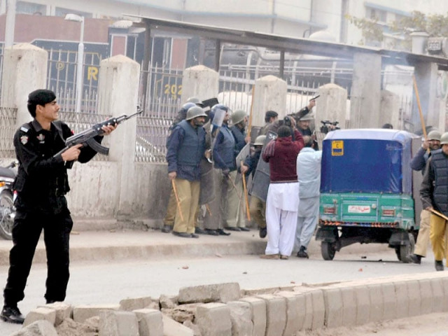 policemen use batons resort to aerial firing and tear gas to disperse protesting tribesmen in front of the peshawar press club on thursday photo inp policemen use batons resort to aerial firing and tear gas to disperse protesting tribesmen in front of the peshawar press club on thursday photo inp