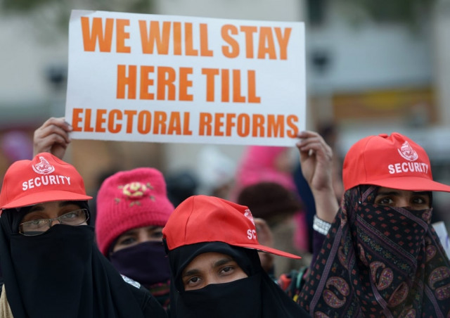 supporters of tahirul qadri hold placards during a protest march in islamabad on january 15 2013 photo afp supporters of tahirul qadri hold placards during a protest march in islamabad on january 15 2013 photo afp