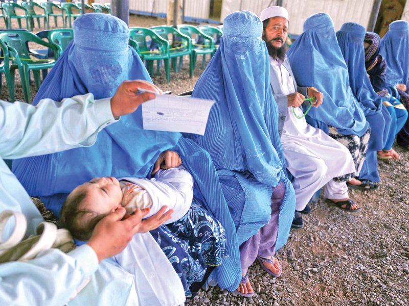 afghan refugees waiting at the united nations high commissioner for refugees unhcr registration centre on the outskirts of peshawar on april 22 2010 before returning to afghanistan photo file