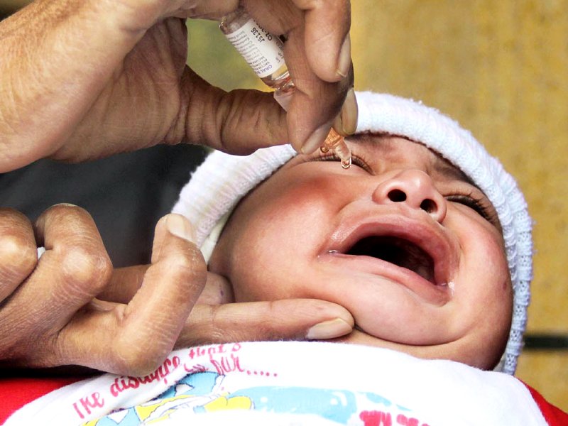 a health worker administers vaccine to a child photo online