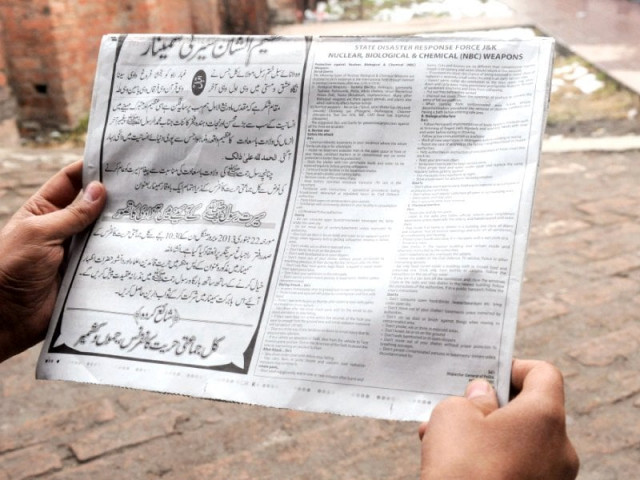 a man reads a notice with instructions concerning a response to nuclear weapons issued by the police photo afp a man reads a notice with instructions concerning a response to nuclear weapons issued by the police photo afp