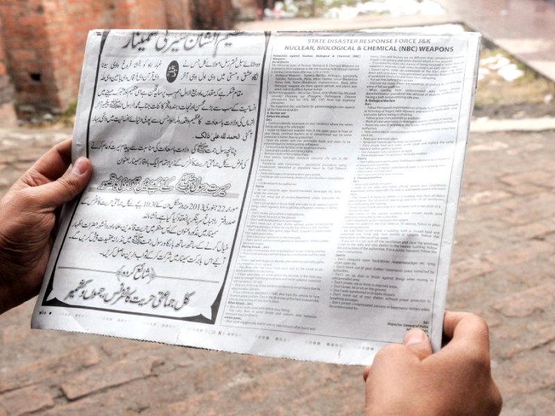 a man reads a notice with instructions concerning a response to nuclear weapons issued by the police photo afp