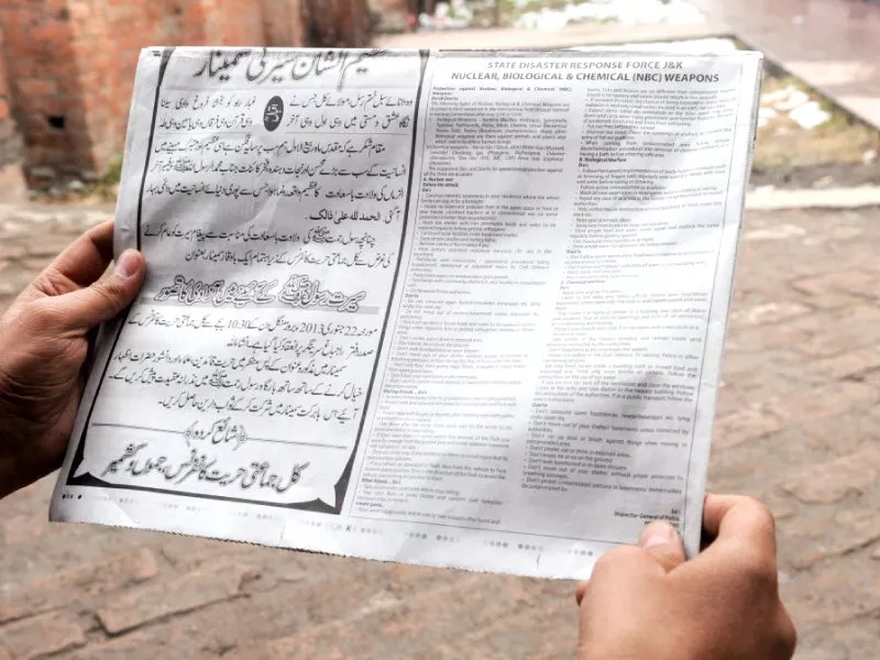 a man reads a notice with instructions concerning a response to nuclear weapons issued by the police photo afp a man reads a notice with instructions concerning a response to nuclear weapons issued by the police photo afp