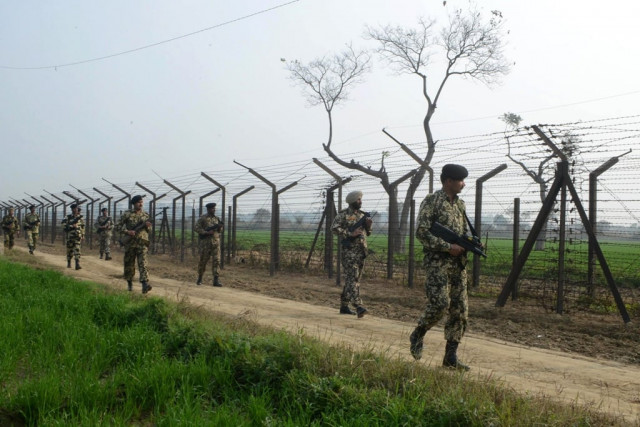 indian border security force soldiers patrol along the india pakistan border fence about 27 km from wagah on january 13 2013 photo afp indian border security force soldiers patrol along the india pakistan border fence about 27 km from wagah on january 13 2013 photo afp
