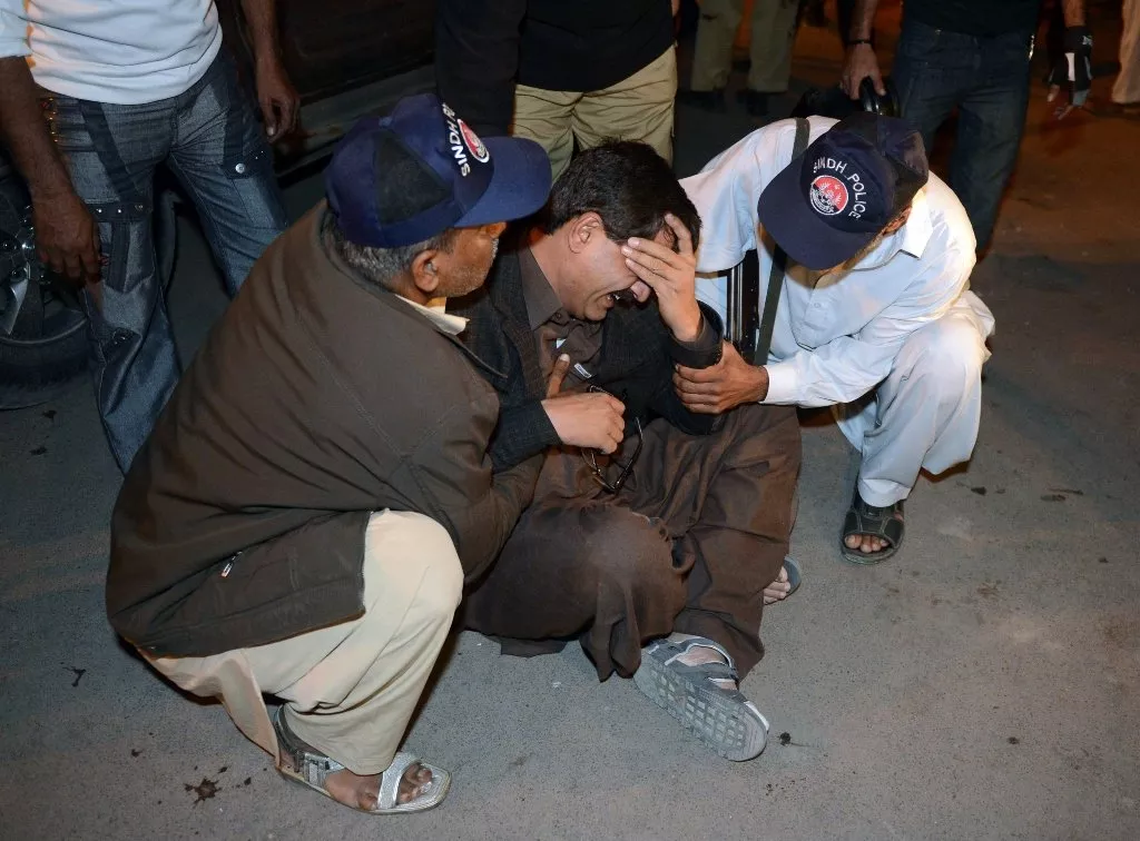 a policeman mourns the death of a colleague after the bomb blast in karachi on january 24 2013 photo afp a policeman mourns the death of a colleague after the bomb blast in karachi on january 24 2013 photo afp