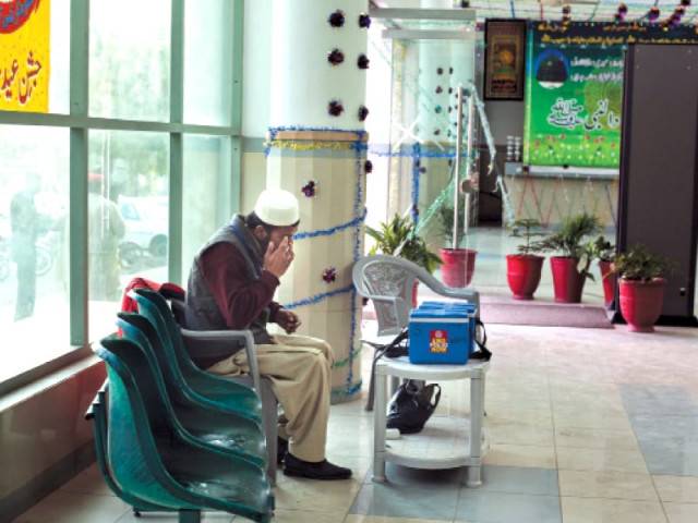 a polio worker sits in the lobby of the polyclinic hospital to administer polio drops he and his colleagues have not been paid since november 2012 photo myra iqbal express a polio worker sits in the lobby of the polyclinic hospital to administer polio drops he and his colleagues have not been paid since november 2012 photo myra iqbal express