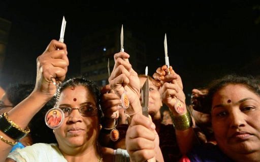 indian women hold knives as they pose for a photo during a function in mumbai photo afp