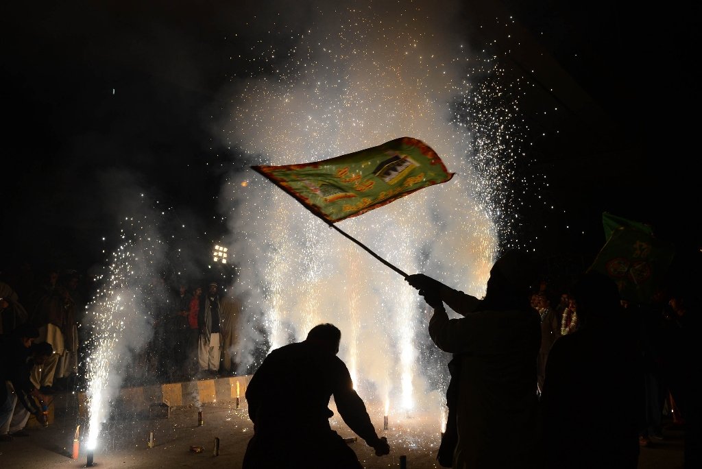 people celebrating on the eve of eid mildun nabi in lahore on thursday photo afp