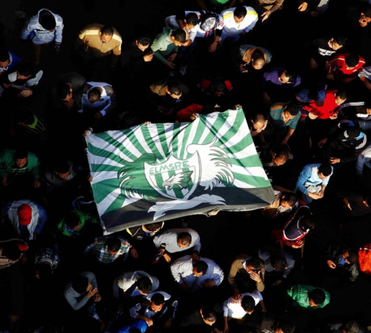 protesters and fans of al masry football club wave their club colours as they take part in a demonstration in front of the prison in port said photo afp protesters and fans of al masry football club wave their club colours as they take part in a demonstration in front of the prison in port said photo afp