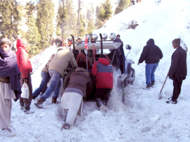 one of the jeeps participating in the rally is stuck in the snow photo express