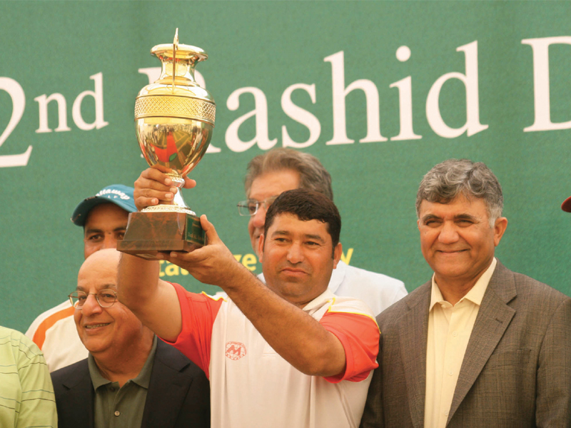 nazir lifts the trophy as chief guest cns pakistan navy admiral asif sandila and bank al habib s chief executive abbas habib look on photo express athar khan