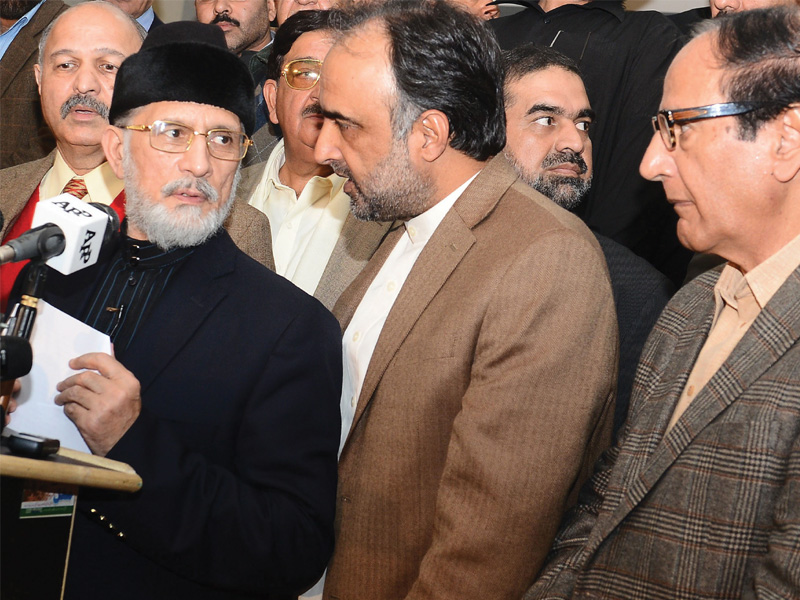 dr tahirul qadri with government officials at a joint news conference in lahore photo afp