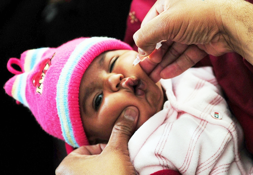 a pakistani health worker administers polio vaccine drops to a young child at a polio vaccination center in karachi photo afp file