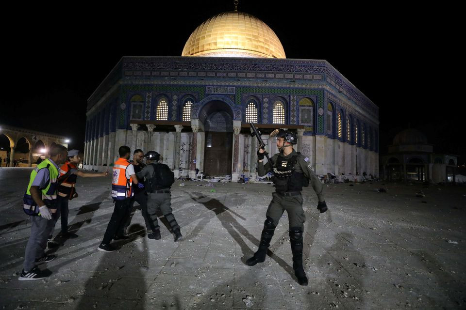 a palestinian hurls stones at israeli police during clashes at the compound that houses al aqsa mosque known to muslims as noble sanctuary and to jews as temple mount amid tension over the possible eviction of several palestinian families from homes on land claimed by jewish settlers in the sheikh jarrah neighbourhood in jerusalem s old city may 7 2021 reuters