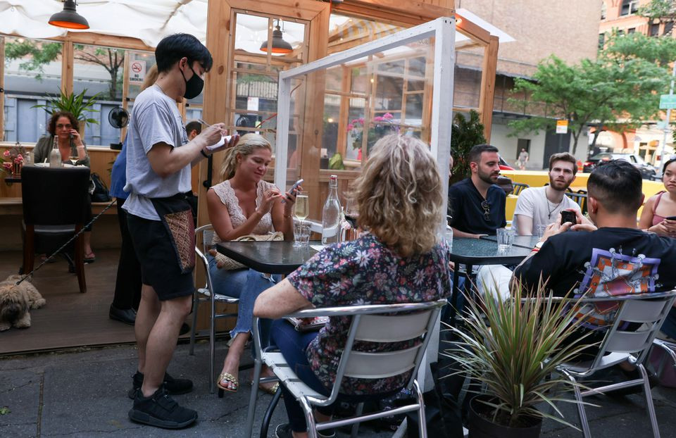 guests enjoy outdoor dining in the manhattan borough of new york city u s may 23 2021 photo reuters